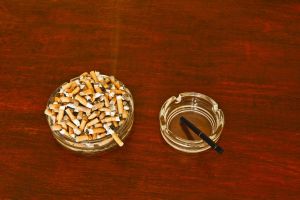 Electronic cigarette and cigarettes in ashtrays