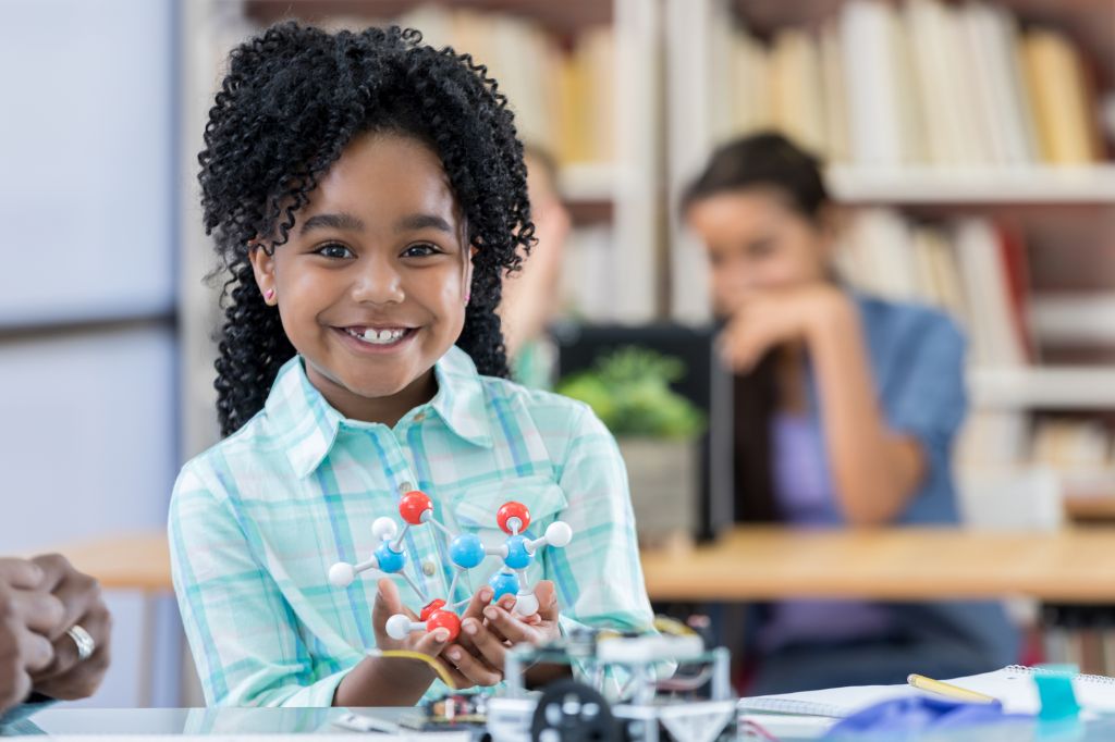 African American elementary schoolgirl learns about molecular structure
