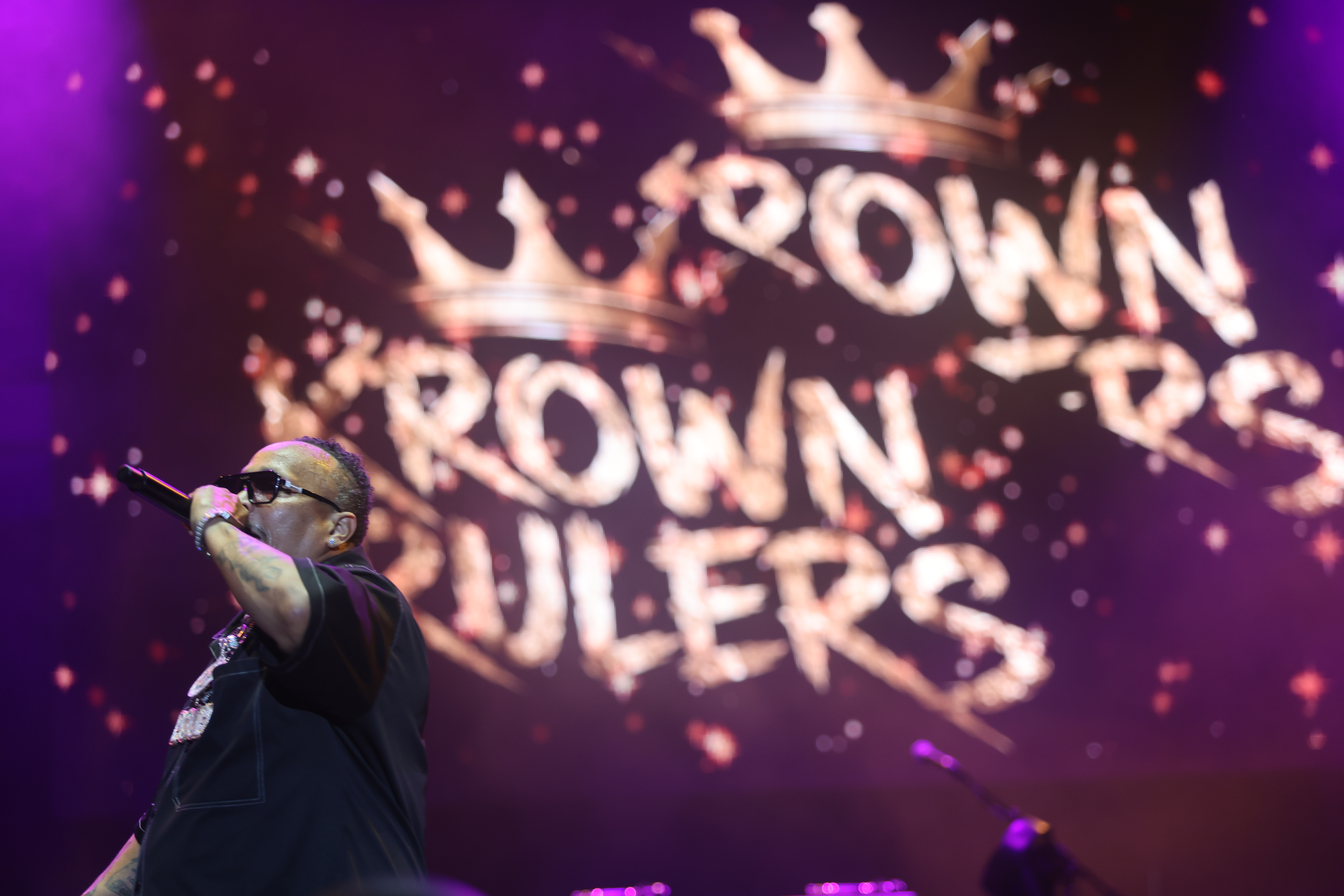 Crown-shaped lights and the text "Crown Royals" on a dark, purple-lit stage.